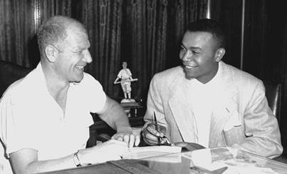 The first African-American player in American League history, Larry Doby signed a major league contract with Cleveland Indians president Bill Veeck on July 5, 1947, then made his MLB debut that day. (Associated Press)