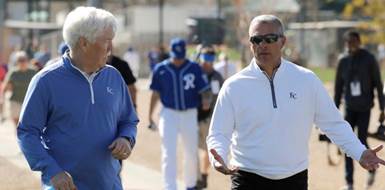 Kansas City Royals owner John Sherman, left, and general manager Dayton Moore walk between practice fields during spring training baseball practice Monday, Feb. 17, 2020, in Surprise, Ariz. (AP Photo/Charlie Riedel)