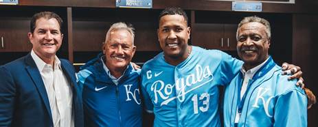 A photo of Mike Sweeney, George Brett, Salvador Perez, and Frank White smiling in the team clubhouse. (Photo by Jason Hanna/Kansas City Royals)