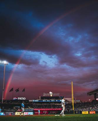 A photo of Kauffman Stadium as a rainbow arches across the sky behind it. (Photo by Amy Kontras/Kansas City Royals)