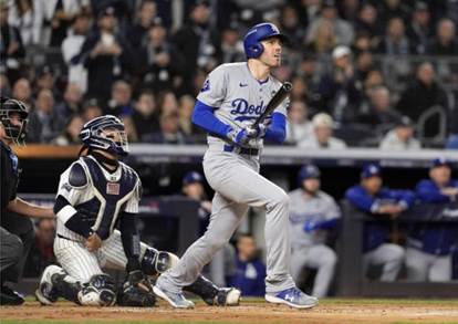 The Dodgers’ Freddie Freeman watches the flight of his two-run home run during the first inning of Game 3 of the World Series on Monday night in New York. Freeman has homered in every game of this series and five consecutive World Series games dating to 2021 with Atlanta. (AP Photo/Godofredo A. Vásquez)
